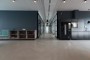 A clear view of commercial property with black walls and modern furniture.