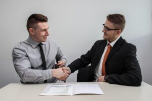 Two florida business brokers shaking hand after a business deal