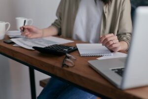 A female Tampa Business Broker calculating at her desk