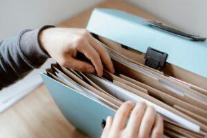 Person sifting through a folder full of documents