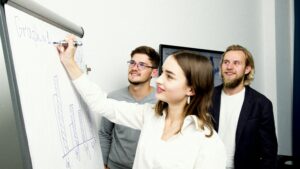 People writing on a whiteboard